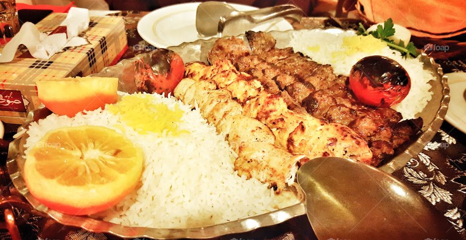 Persian grill, chicken and veal kebab with saffron rice and grilled tomatoes
