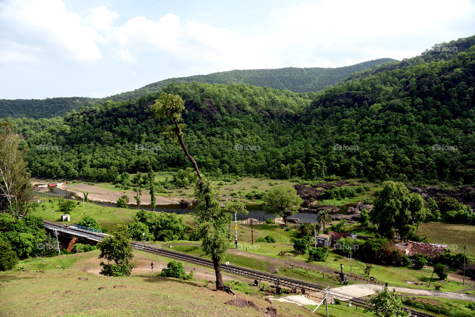 there are mountain , river, railway track, forest
