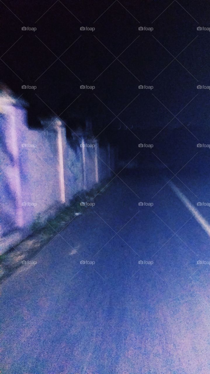 The street atmosphere is quiet and dim