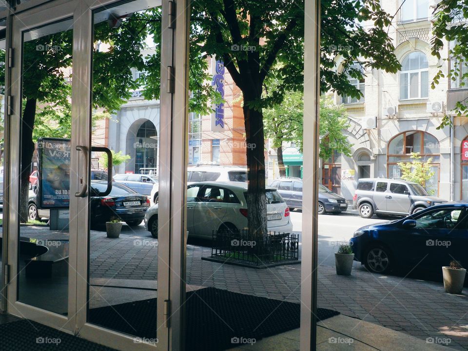 an incredible reflection of the street in a building window