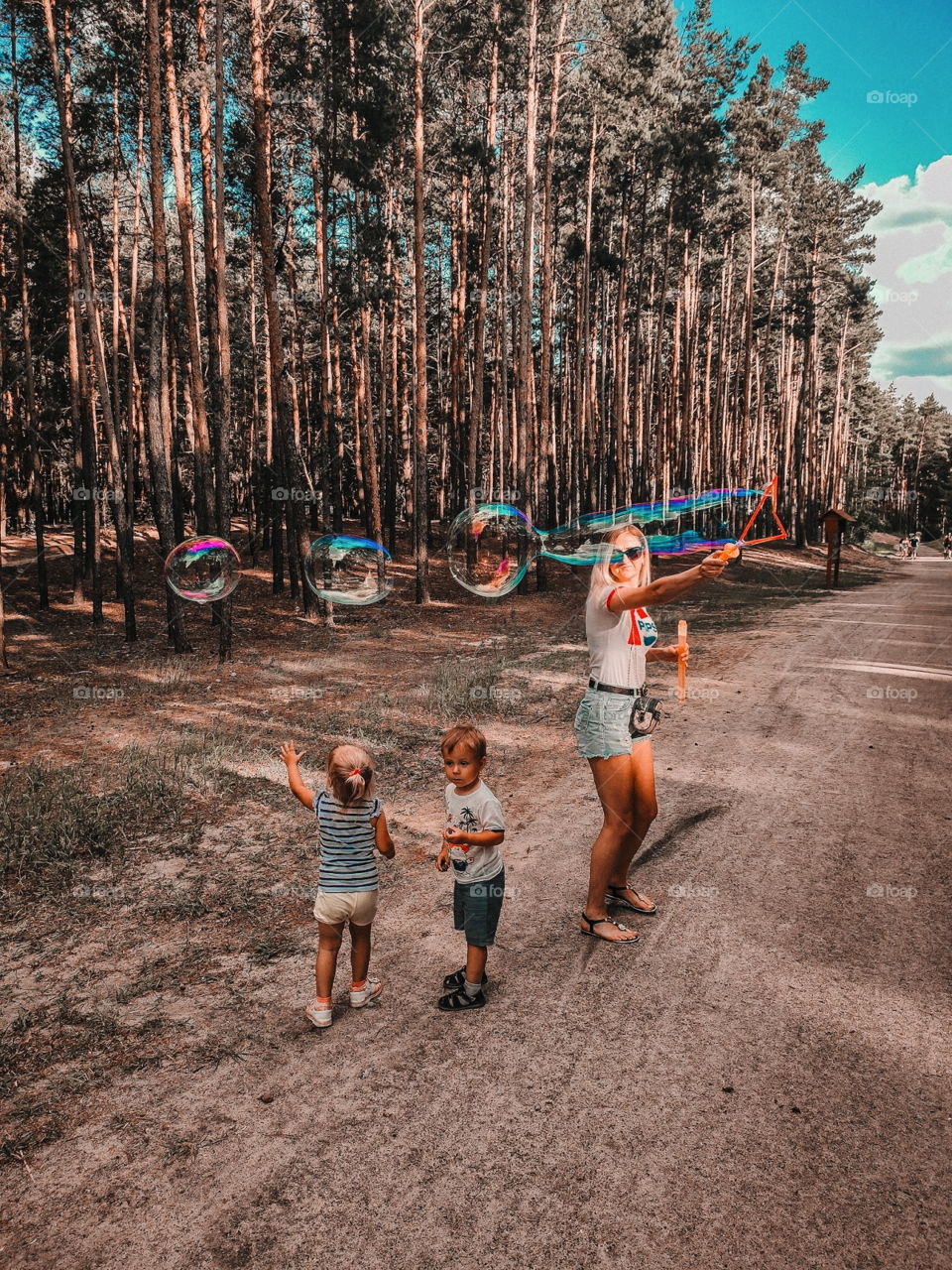 happy kids play with soap bubbles