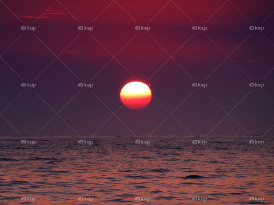 Bright sun on dramatic sky over the sea