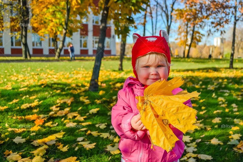 cute little girl with yellow leaf