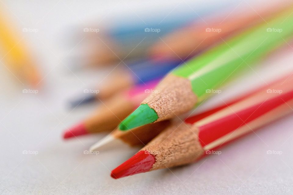 Wooden pencils, focus on green and red one