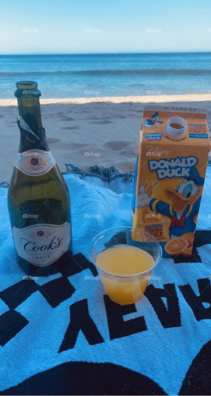 Relaxing day at the beach with mimosa 