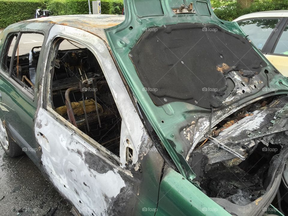 Burnt-out car in the affected area Kroksbäck in Malmö, Sweden. Youths set fire to cars at night.