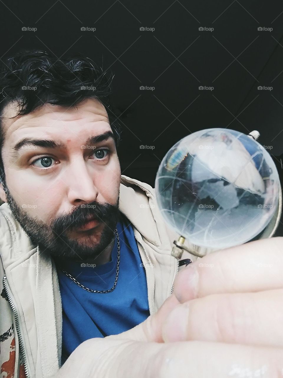 man with glass globe