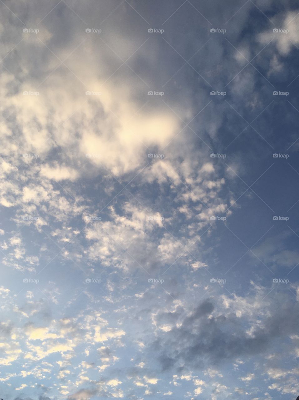 Glorious June sky, pale blue with soft clouds