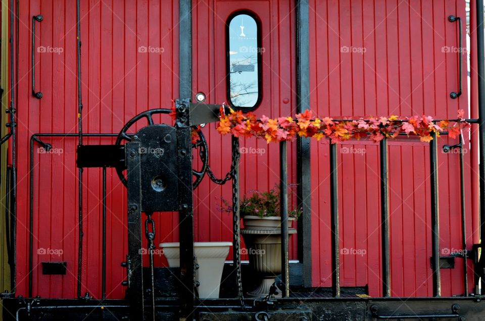 A gorgeous red background showcases vintage tools as well as colorful flowers and pots.