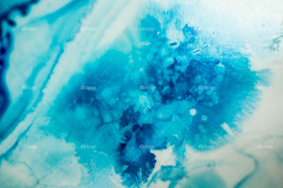 The ink to refill the printer cartridge was spilled onto the white washbasin and the paints blended into abstract drips and patterns.