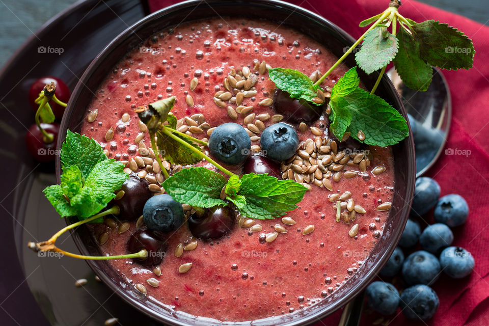Cherry smoothie bowl with blueberry, cherry, flax seeds and mint