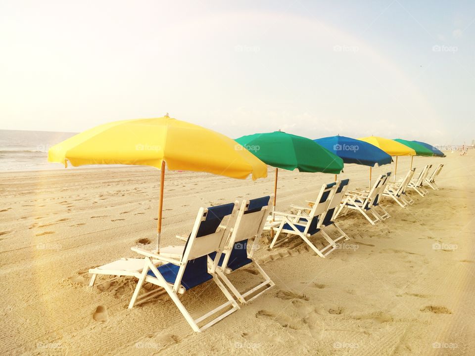 Beach chairs. A row of beach chairs taken in the golden hour just after sunrise.