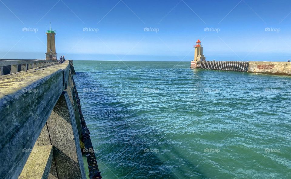 The piers and lighthouses of the harbor of Fécamp, France, forming a gate to the open sea