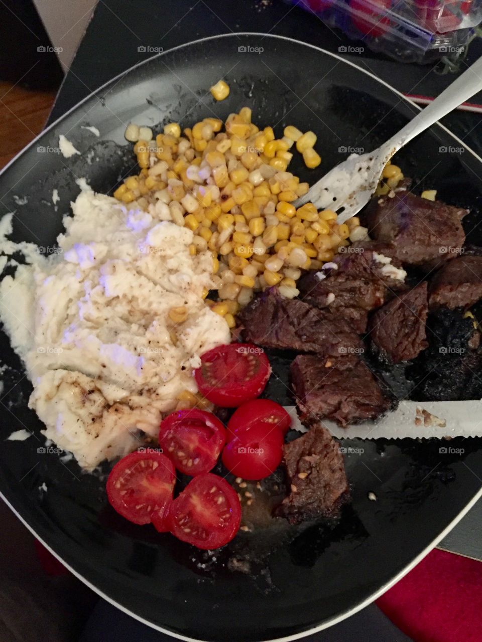Steak, mashed potatoes, corn and tomatoes