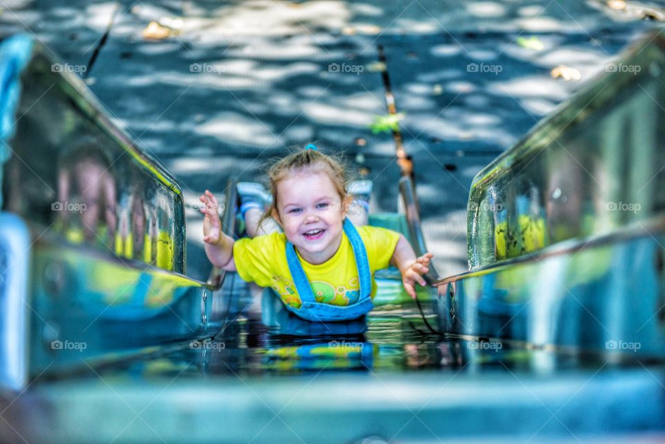 High angle view of a cute girl playing on slide