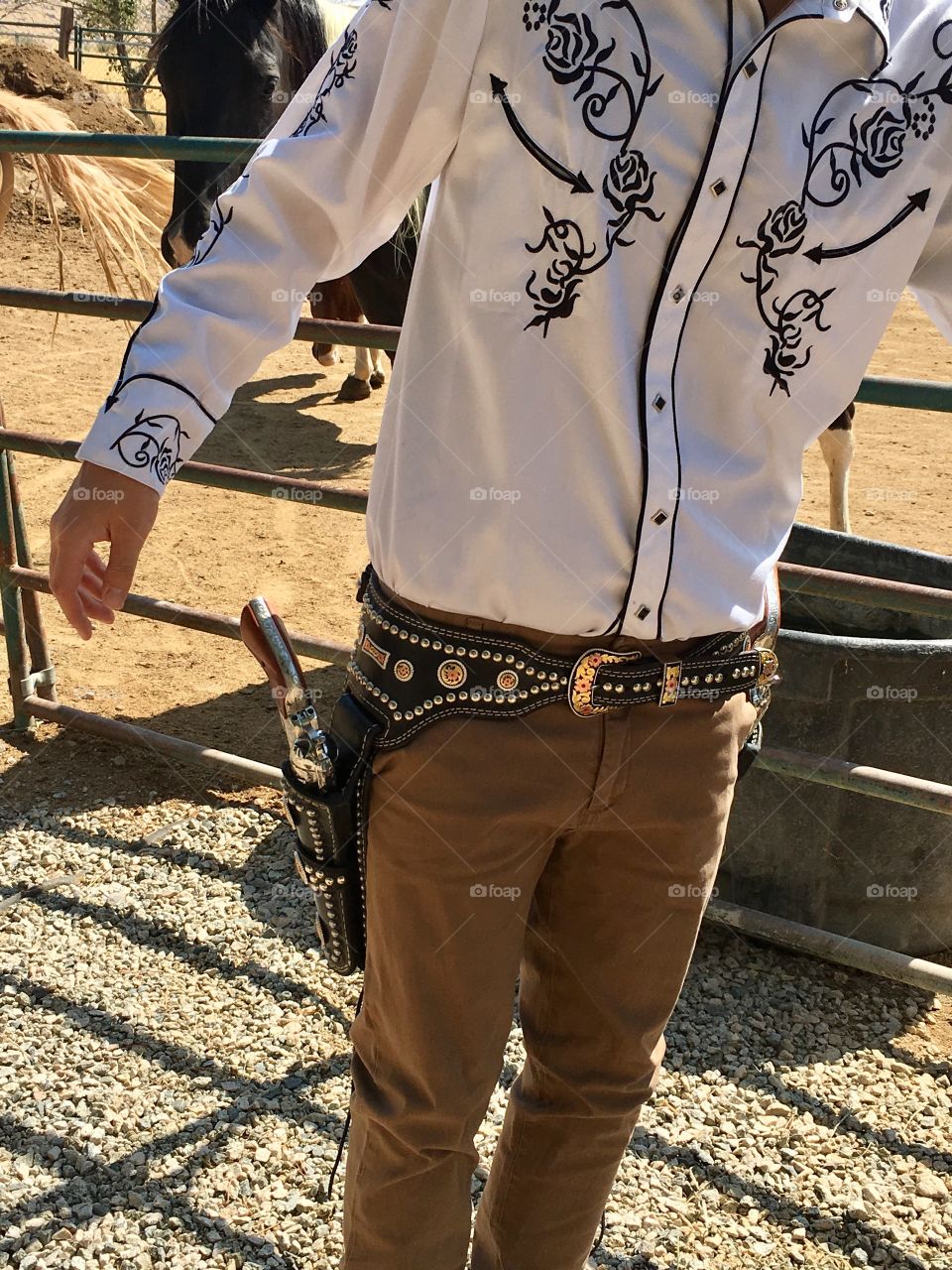 Cowboy wearing western shirt, belt and gun holsters 