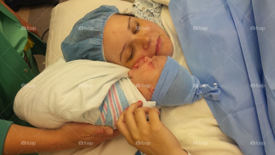 Mother and newborn baby child after labor in a hospital
