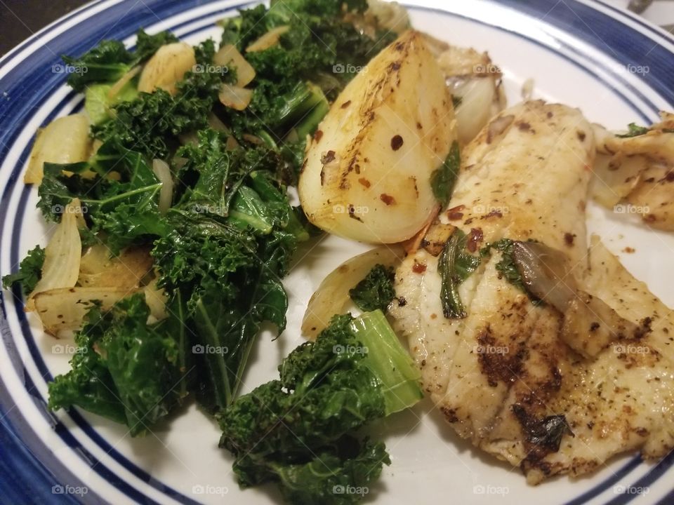 Pan fried tilapia fillet with scattered greens