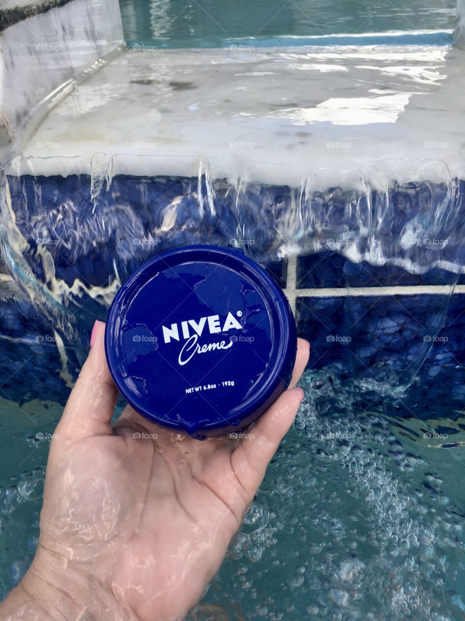 Nivea creme held by hand