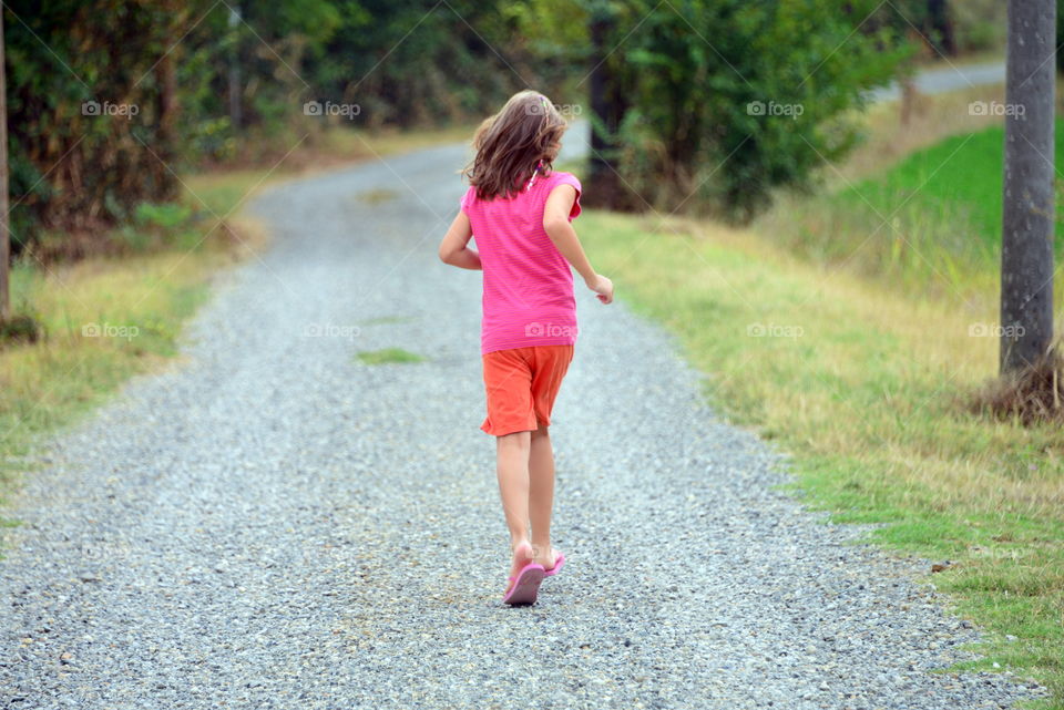 a little girl running in the park