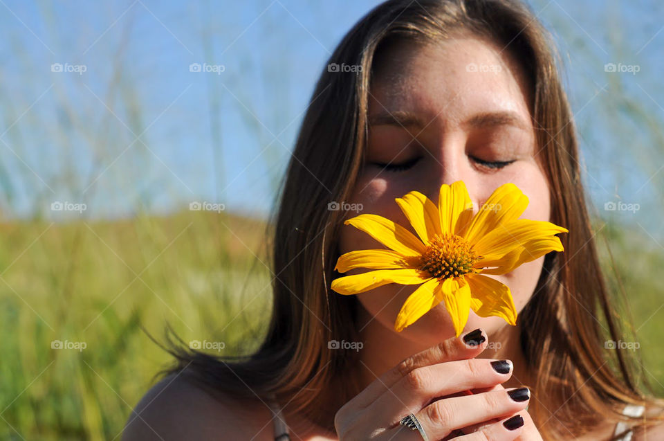 Girl smelling a flower