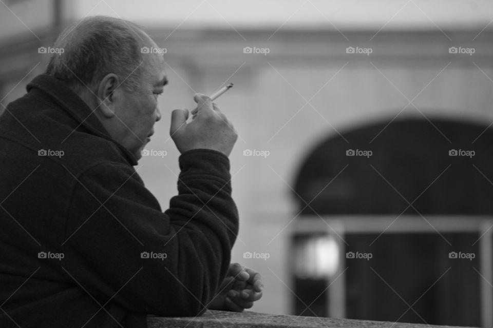 Thinking man smoking a cigarette
