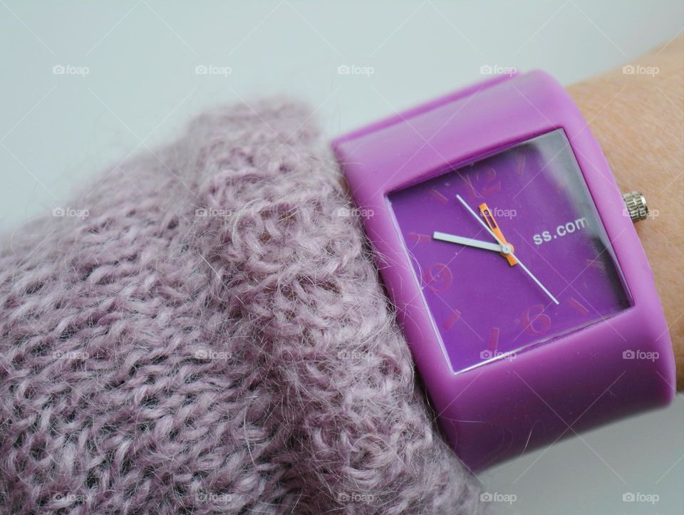 purple clock in the female hand object