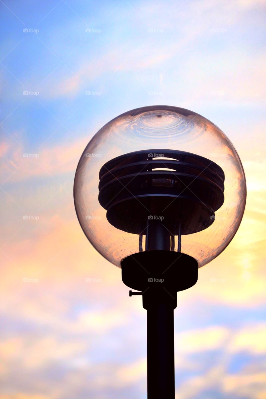 Lamp against dramatic sky