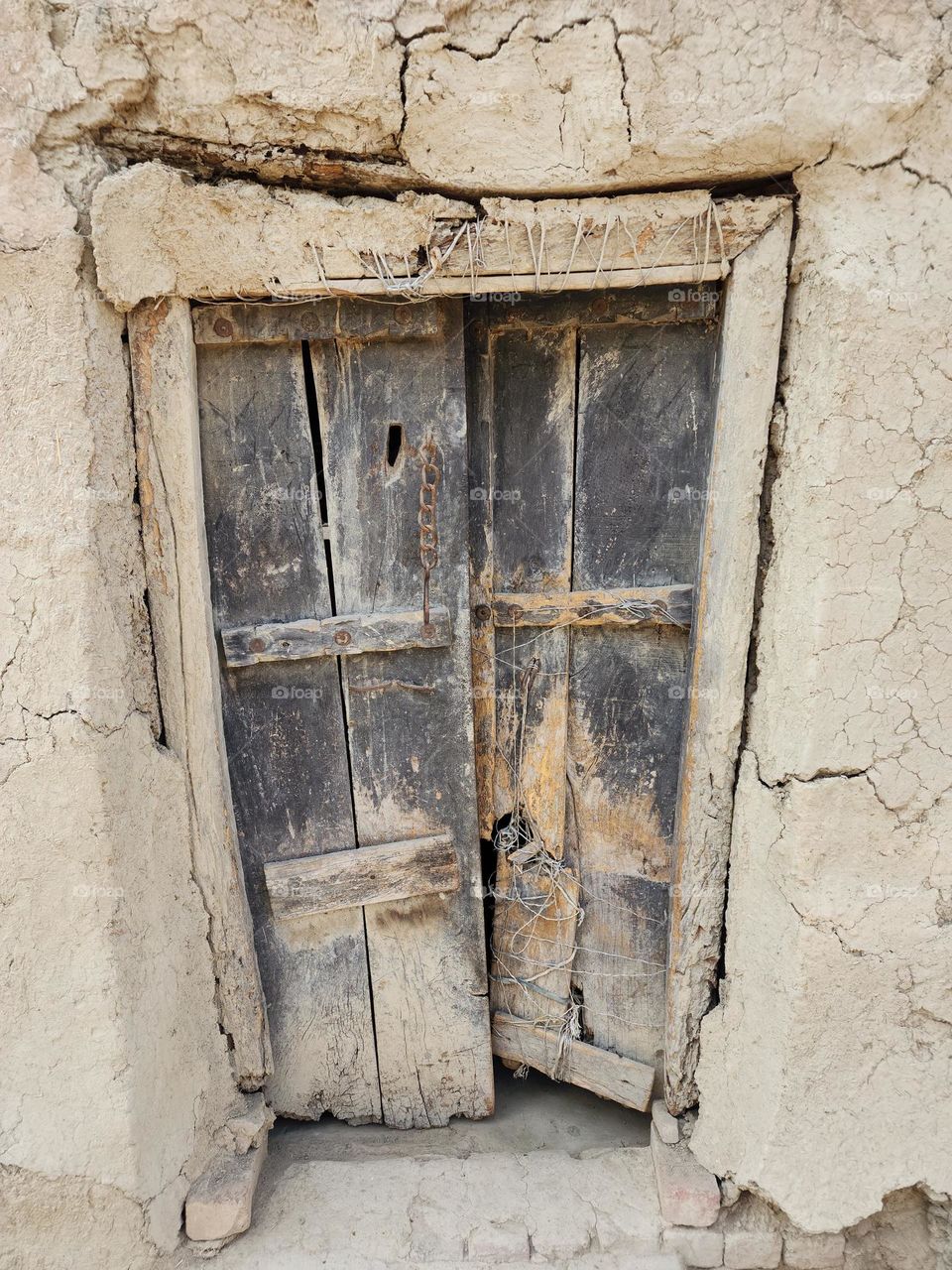 This old vintage door has seen many emotions and depicts the old vintage time of mud house