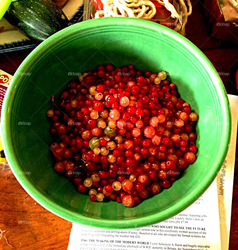 Green bowl with berries. Green bowl with currents and gooseberries