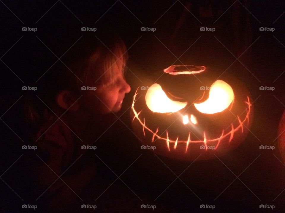 Child with Halloween pumpkin