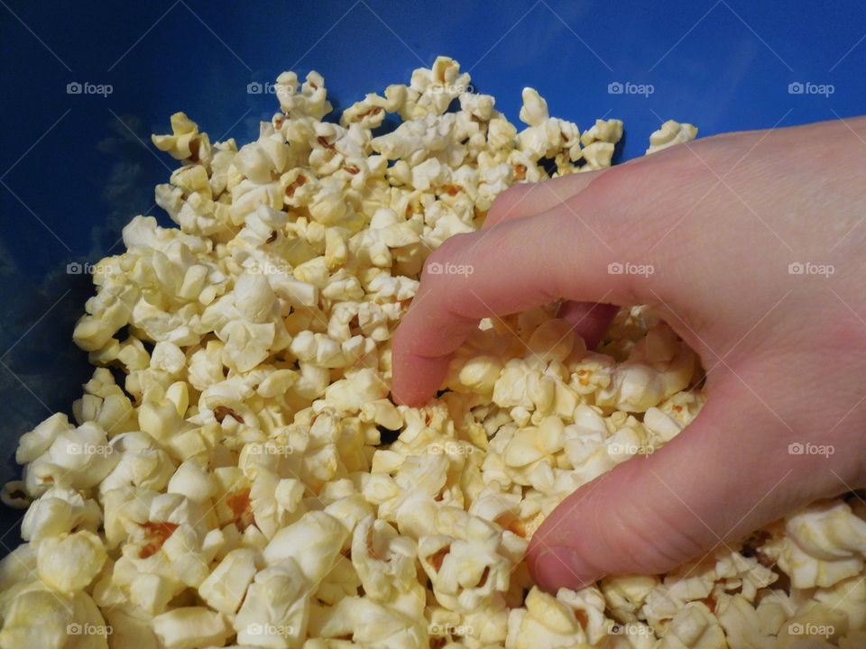 Eating popcorn in blue bowl