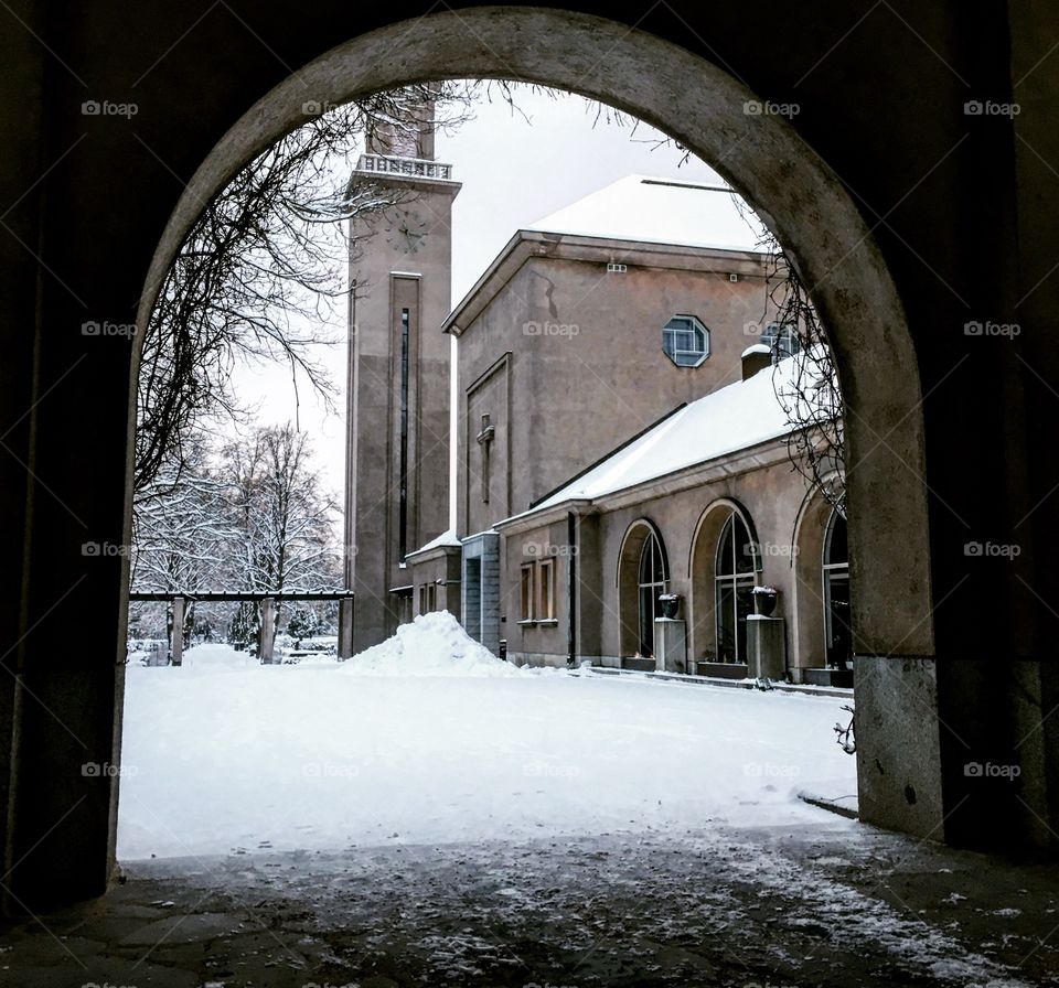 Church through the column in the snow 