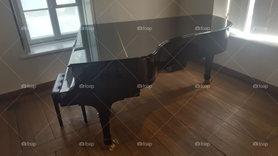 A grand piano in a simple room