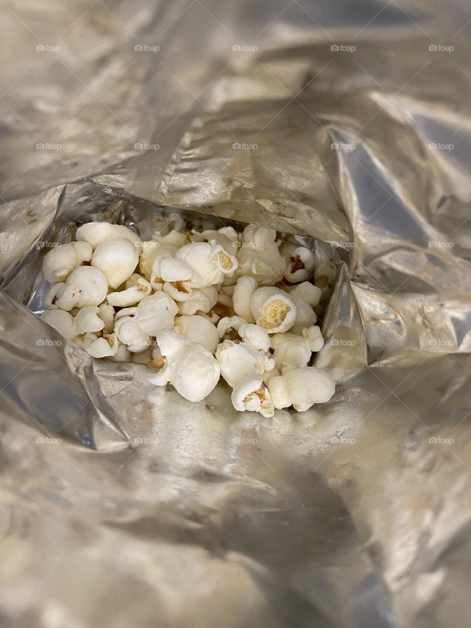 White cheddar popcorn at the bottom of a Smartfood White Cheddar Popcorn bag. You never want to reach the end, but you know it’s coming!