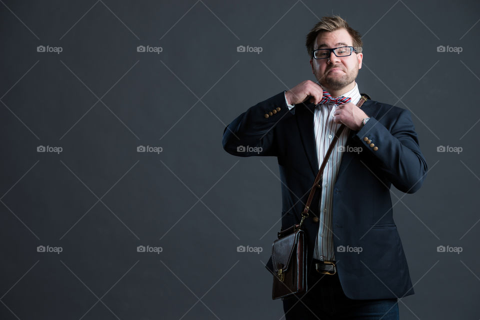 Young man fixing his tie.