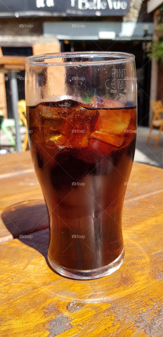 Glass of coke in the sunshine