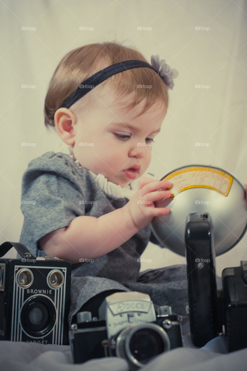Baby with antique camera 
