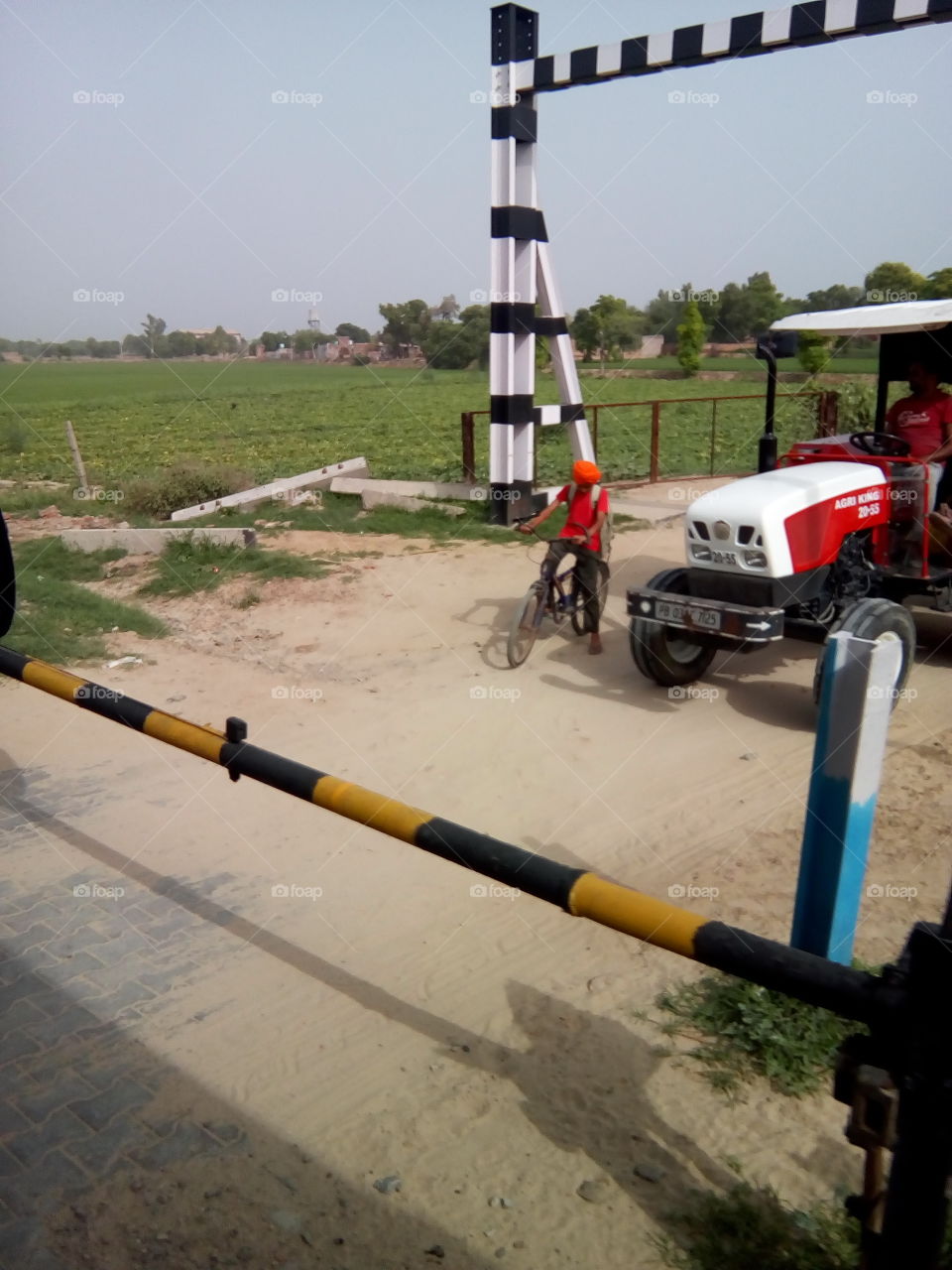 natural beautiful seen of a village in India- a railway crossing.