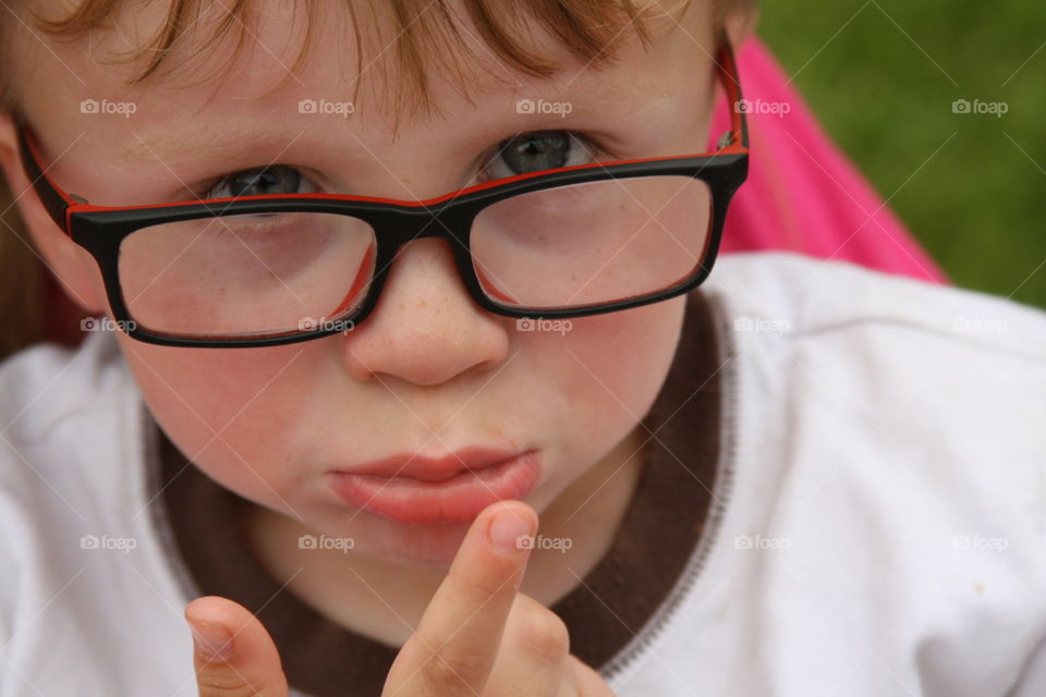 Portrait of little sad boy in eyeglasses