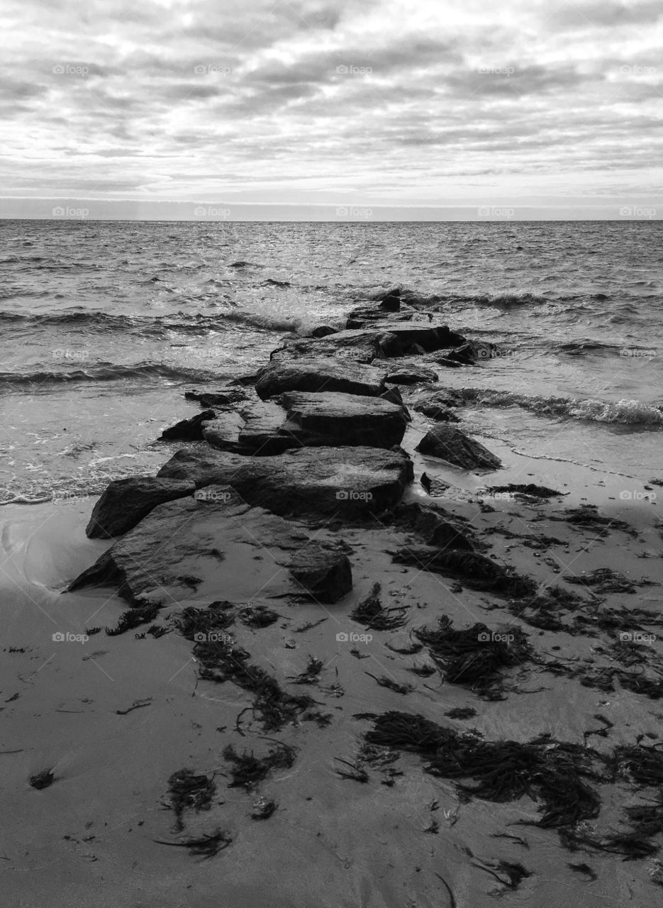 Symmetry - a jetty separating the beaches perfectly down the middle.  Black and white emphasizes the positioning. 