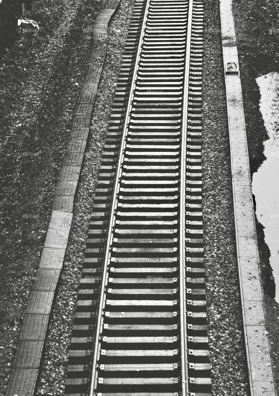 Railroad tracks in black and white.