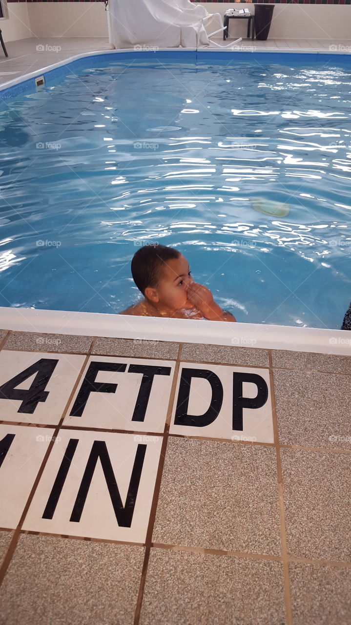 A boy swimming in the swimming pool