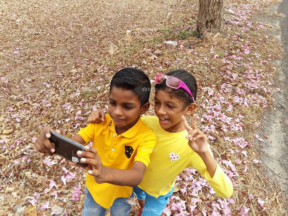 High angle view of two children's taking selfie