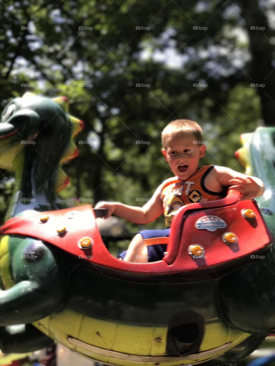 A little boy riding on animal at playground