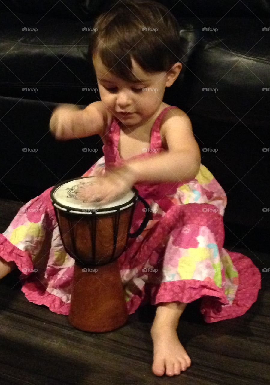 Little girl playing drum