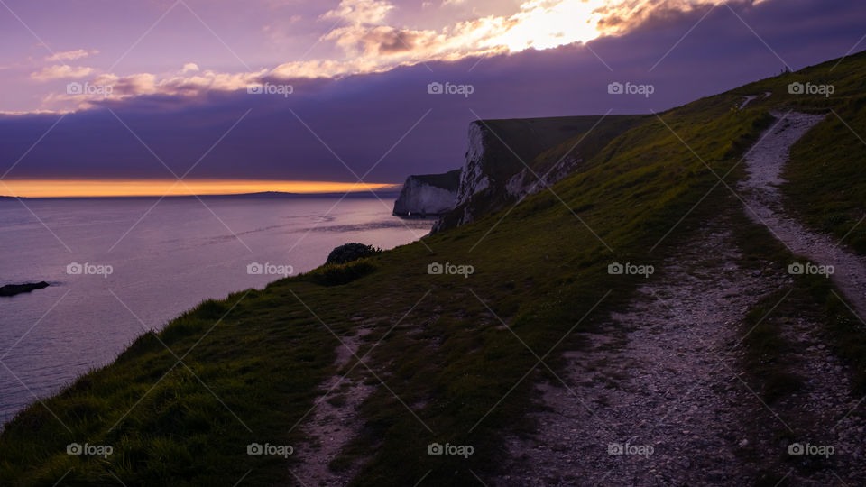 A colourful sunset over the Durdle Door Cliffs.