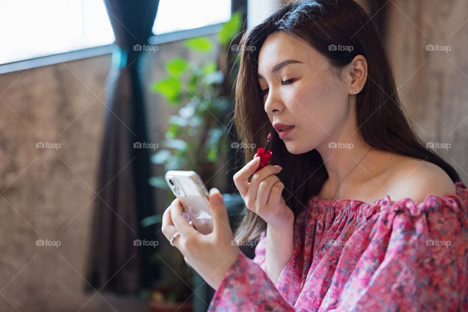 Woman applying makeup 