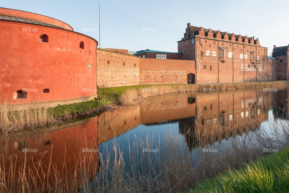 Malmö museum reflecting in water at sunset