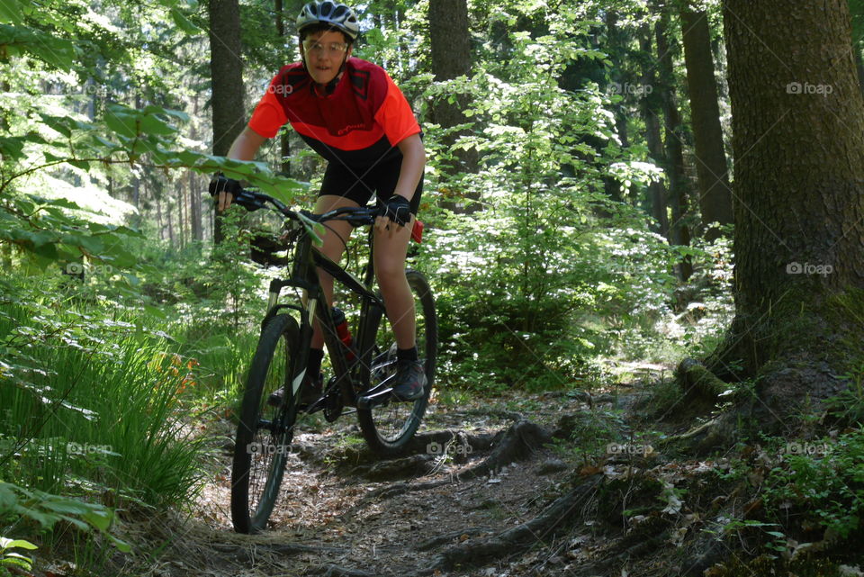 Teenager on Mountainbike in The Woods 